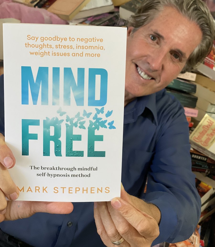 Mark Stephens holding his book Mind Free